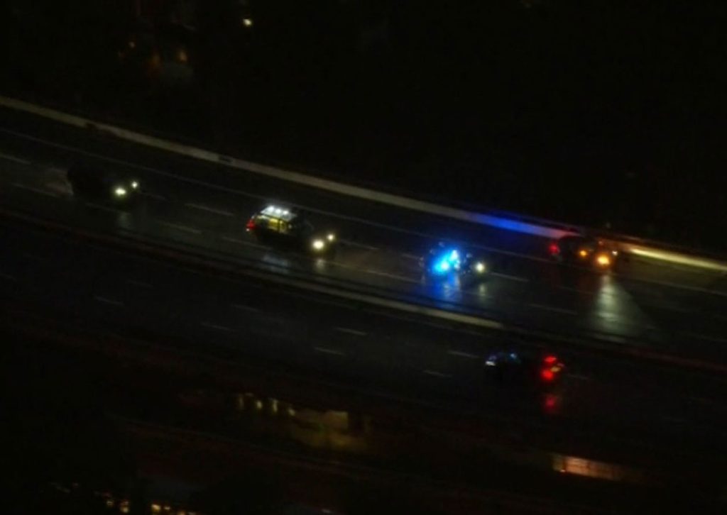 A night-time aerial view of the convoy of vehicles carrying the body of Queen Elizabeth along the Westway in London