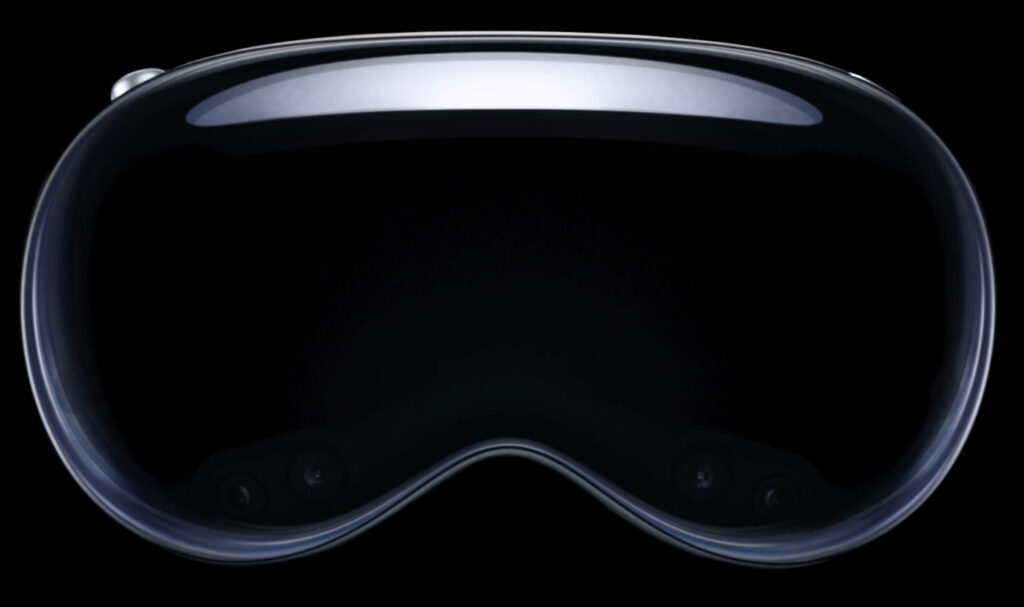Stylised front-on photo of Apple Vision Pro VR headset against a black background